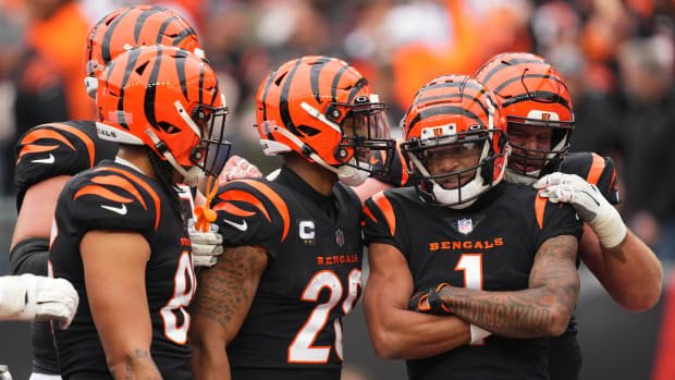 Dec 11, 2022; Cincinnati, Ohio, USA; Cincinnati Bengals wide receiver Ja'Marr Chase (1) is congratulated by Cincinnati Bengals running back Joe Mixon (28) and Cincinnati Bengals center Ted Karras (64) after a touchdown catch in the second quarter during a Week 14 NFL game against the Cleveland Browns at Paycor Stadium. Mandatory Credit: Kareem Elgazzar-USA TODAY Sports